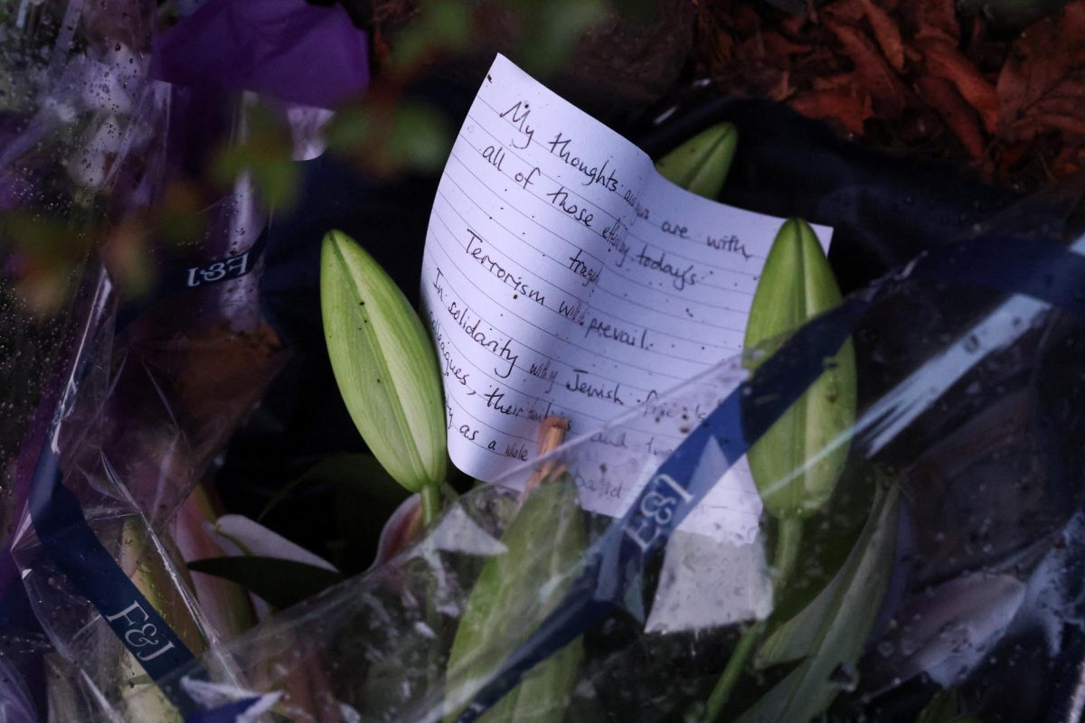 A note is left with flowers, near the Manchester synagogue, where multiple people were killed on Yom Kippur, in what police have declared a terrorist incident, in north Manchester, Britain, October 3, 2025. REUTERS/Hannah McKay