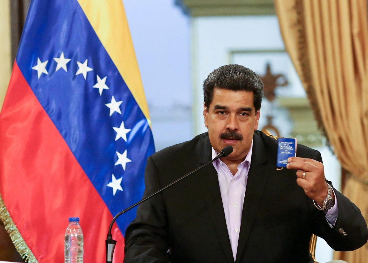 Venezuela's President Nicolas Maduro holds a copy of the Venezuelan constitution while he speaks during a meeting with members of the Venezuelan diplomatic corp after their arrival from the United States, at the Miraflores Palace in Caracas, Venezuela January 28, 2019. Miraflores Palace/Handout via REUTERS
